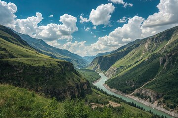 Fototapeta premium Stunning mountain scenery featuring a river flowing through a valley on a bright summer day with clouds.