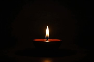 Gorgeous glowing terracotta lamp plate at night with dramatic lighting and focused detail