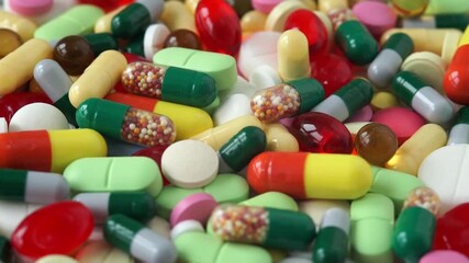 Close up of colored medical pills rotate in circle. Pills and drugs. Pharmaceutical Industry. Medicine concept