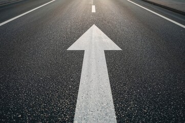 Directional arrows on a textured paved surface