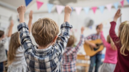 Children Raising Arms in Classroom with Adult Playing Guitar