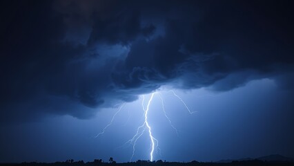 A dramatic lightning strike illuminates the dark stormy sky with electric blue brilliance.