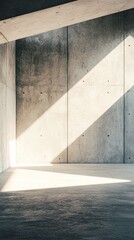 Obraz premium Minimalist concrete interior with dramatic light casting geometric shadows across textured walls and floor, creating a serene architectural composition of light and shadow
