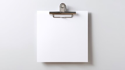 Blank white paper clipped to a wall