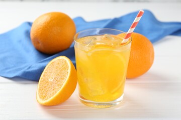 Refreshing soda water with orange slice in glass and fresh fruits on white wooden table, closeup