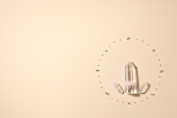 Different gemstones on beige background, flat lay. Space for text