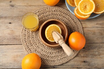 Freshly squeezed orange juice, fruits and juicer on wooden table, flat lay