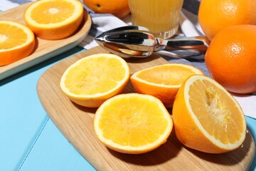 Oranges and squeezer on blue wooden table, closeup. Making fresh juice
