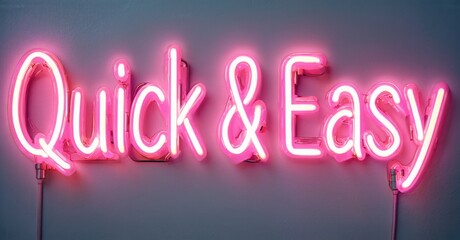 Bright pink neon sign displays words Quick Easy. Simple message, modern aesthetic, wall mounted installation.