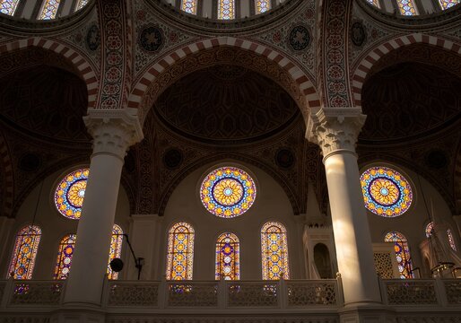 Interior view of the rustem pasha mosque in istanbul, turkey, featuring stained glass windows, arches, columns and a decorated dome