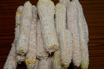the corn cobs after the kernels have been removed, the edible seeds of the maize plant, typically...
