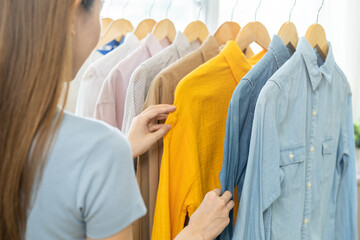Choose clothes to wear, hand of asian young woman, girl try on appare, happy choice of shirt,...