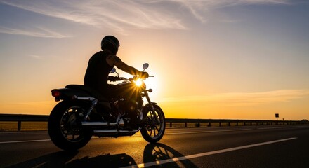Golden Hour Freedom - Motorcyclist Silhouetted Against a Radiant Sunset on a Reflective Road.