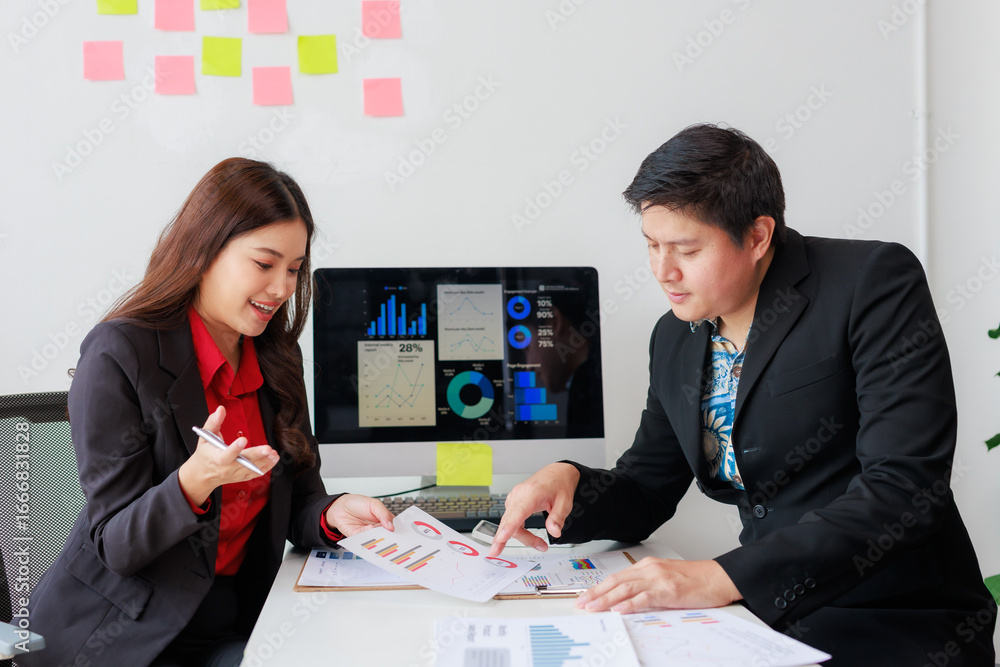 Poster two businesspeople are discussing financial data displayed on a computer screen and printed document