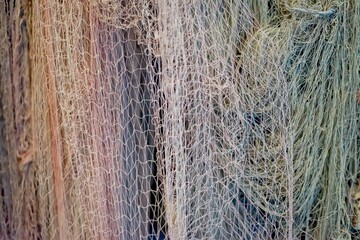 Close-up of colorful fishing nets hanging, detailed texture and pattern, symbol of fishing...