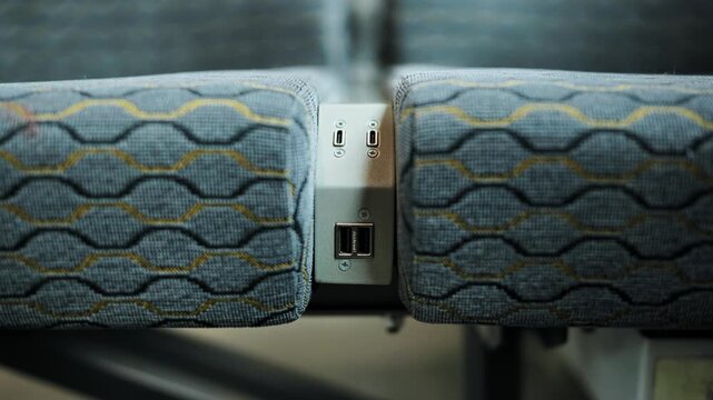 Usb charging ports between passenger seats facilitating charging of electronic devices on public transport
