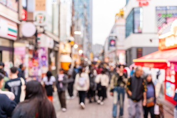 Blurred image of tourists and locals exploring city shopping streets in Tokyo, Japan
