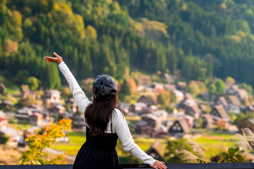 Young female traveler enjoying with colorful foliage at shirakawa-go in autumn, Travel japan concept