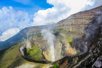 Active Volcano with Smoke Eruption and Dramatic Landscape