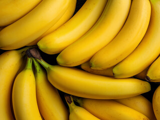 Bunch of ripe yellow bananas on black background. 