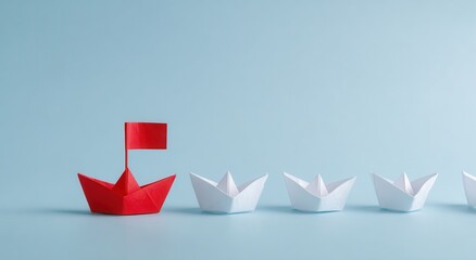 Red paper boat leads white paper boats in a row