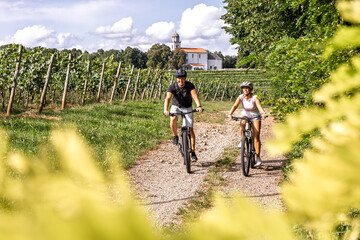 Couple riding e-bikes on Karst vineyard trail