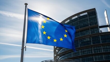 European Union flag waving proudly against the European Parliament building in Strasbourg - Powered by Adobe