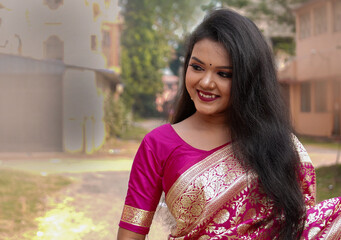 Portrait of beautiful indian bride woman in a wedding saree. Young bengali hindu woman model....
