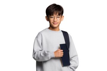 Young schoolboy with glasses smiling confidently, holding a book and wearing a backpack