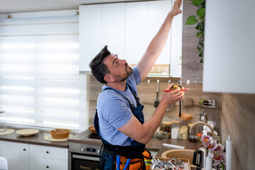 Home improvement project with a man working in a modern kitchen during the daytime