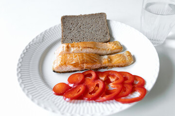 Plate of fried fish, bread, red pepper