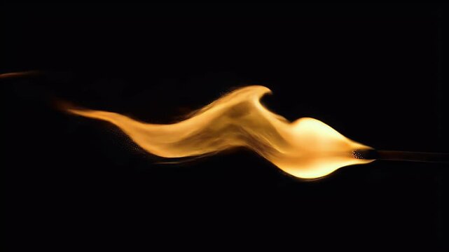 Burning Matchstick Flame Against Black Background