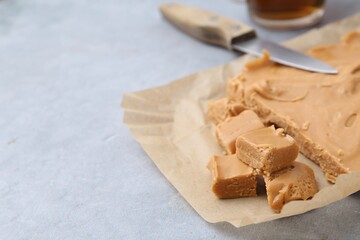 Making candies. Homemade caramel dessert on light table, closeup. Space for text