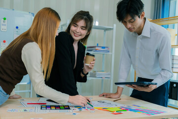 Fototapeta premium A team of developers collaborates to plan UXUI designs, working on wireframes for website and mobile application prototypes, surrounded by user flow sketches and design tools.