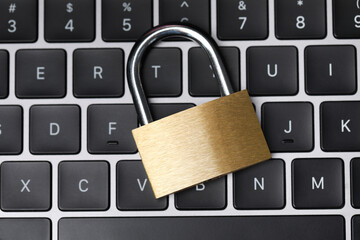 Cyber safety. Metal padlock on keyboard, top view