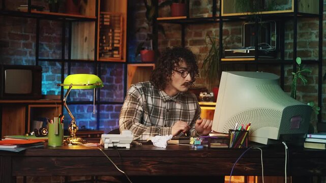 Shocked male programmer in 80s having problems with computer virus, retro office