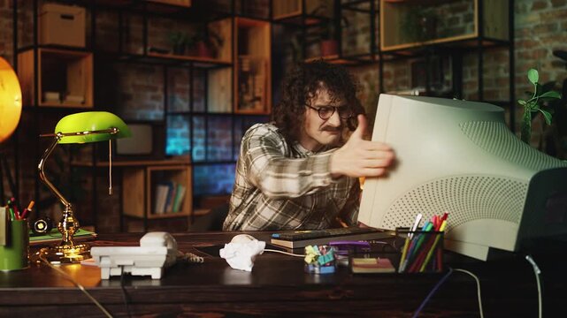Upset male developer having problems with computer program, 90s lifestyle