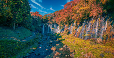 Shiraito Falls with Mt. Fuji and colorful autumn leaf in Fujinomiya, Shizuoka, Japan.