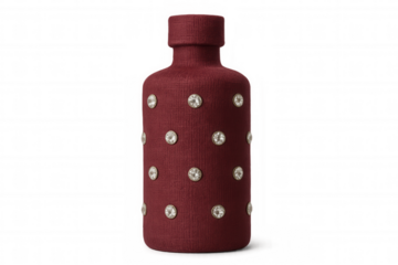 Sparkling red fabric-covered bottle embellished with rhinestones, glinting against transparent backdrop