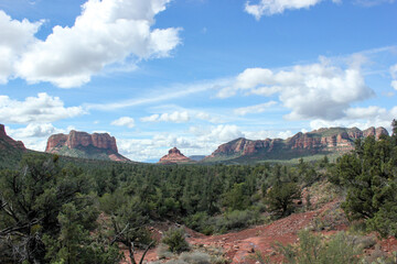 Red rock canyons against blue sky with massive cloudscape in Sedona, Arizona 