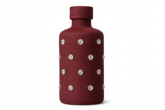 Sparkling red fabric-covered bottle embellished with rhinestones, glinting against transparent backdrop