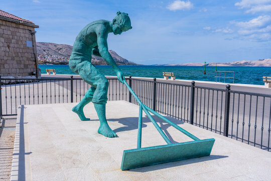 Pag, Croatia, 9 April 2025 -  Statue of a man delving salt (Paski solar)
