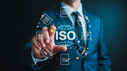 Obraz premium Businessman activating ISO certification with futuristic interface, business compliance concept