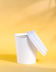 Generated image White Coffee Cup Mockup with Lid on Yellow Background