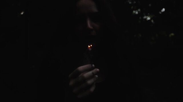 The witch woman blows out a black candle