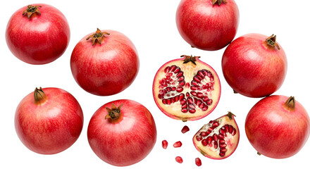 A display of whole and halved pomegranates with seeds scattered on a black background for presentation isolated on transparent white background]