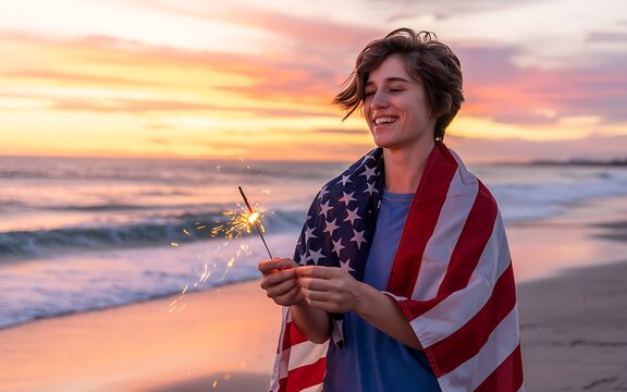 Woman with sparkler on beach at sunset