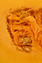 cut orange ripe pumpkin for cooking, cut into pieces sweet pumpkin in the kitchen