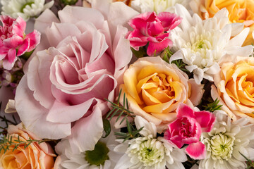 a beautiful gift arrangement of a large variety of flowers of different colors, a flower arrangement for giving from different colors and different types of flowers