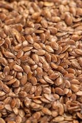 wet flax seeds are used to produce food or linseed oil or germinate for dietary nutrition, covered with drops of water, a large amount of light brown flax seeds